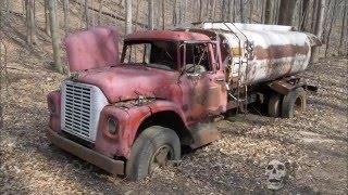 Abandoned trucks in woods in America. Abandoned pickup in USA. Abandoned semi truck