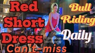 Red short dress Girl ️ bull  riding in Benidorm Spain ! Mechanical bull  riding! Benidorm bull