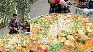 A Chinese Woman Cook Free Meals / Noodles for the old on the Street in Downtown a Village