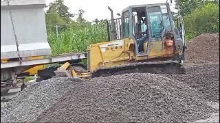 bulldozer pushing gravel rock