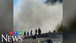 Massive section of cliff collapses at Scarborough Bluffs in Toronto, sending beach-goers running