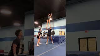 Teammates are learning a new coed cheer skill!