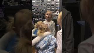 Kya and Ava singing in the mirror at the shoe store