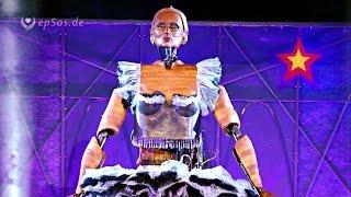 Large Robot Doll who is larger than an Elephant.