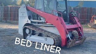 Painting skid steer with Raptor bed liner /custom coatings.