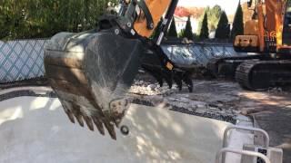 Excavator digging a pool demo crushing concrete Demolition video